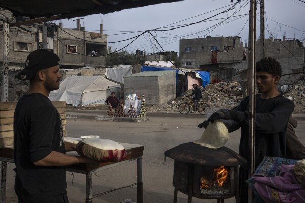 فلسطينيون يخبزون الخبز في أحد شوارع رفح، قطاع غزة، الجمعة، 23 فبراير، 2024. لجأ ما يقدر بنحو 1.5 مليون فلسطيني نزحوا بسبب الحرب إلى رفاحور، والذي من المحتمل أن يكون التركيز التالي لإسرائيل في حربها ضد حماس. (AP Photo / فاطمة شبير)