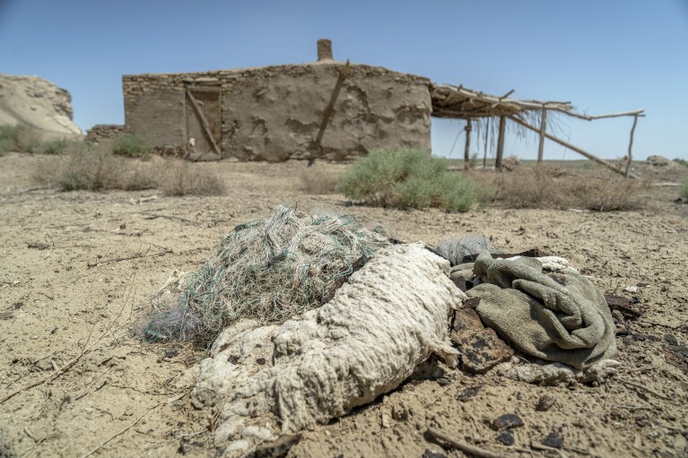 شبكة صيد بالية بجوار مبنى مهجور على ضفاف بحر آرال الجاف، بالقرب من مويناك، أوزبكستان، السبت 24 يونيو 2023. (AP Photo/Ebrahim Noroozi)