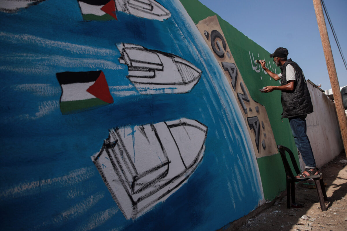 الفنانين الفلسطينيين يرسمون على الجدران يصور "السومود العالمي الأسطول" على جدار مبنى لدعم الأسطول ، الذي أبحر لتقديم المساعدات الإنسانية إلى غزة ، في دير البلا ، غزة في 3 أكتوبر 2025.